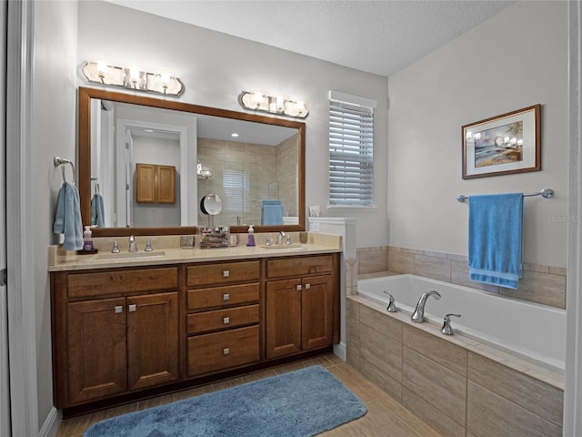 8818 Bismarck Palm Dr, Winter Garden, FL 34787 - full bath with double vanity, a garden tub, a textured ceiling, tiled shower, and tile patterned flooring