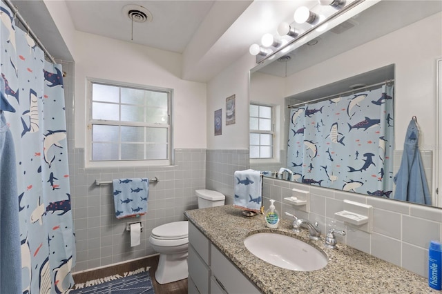 1770 Chinook Trl, Maitland, FL 32751 - full bathroom featuring tile walls, vanity, toilet, wainscoting, and a shower with shower curtain