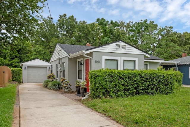 1021 N Forest Ave, Orlando, FL 32803 - view of front of property featuring stucco siding, driveway, an outdoor structure, a chimney, and a shingled roof