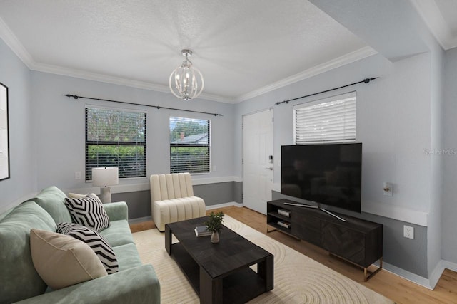 1021 N Forest Ave, Orlando, FL 32803 - living room with a chandelier, light wood-type flooring, ornamental molding, baseboards, and a textured ceiling