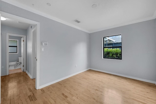 1021 N Forest Ave, Orlando, FL 32803 - unfurnished room with light wood finished floors, crown molding, and baseboards