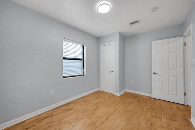 1021 N Forest Ave, Orlando, FL 32803 - unfurnished bedroom featuring light wood-style flooring and baseboards