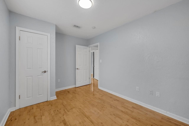 1021 N Forest Ave, Orlando, FL 32803 - unfurnished bedroom with light wood-style floors and baseboards