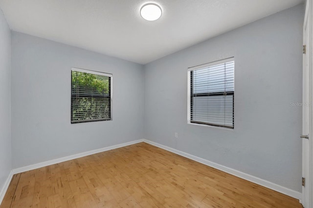 1021 N Forest Ave, Orlando, FL 32803 - spare room with wood finished floors and baseboards