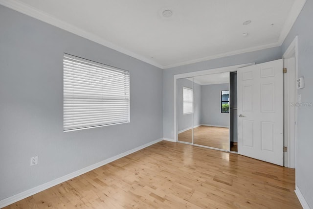 1021 N Forest Ave, Orlando, FL 32803 - unfurnished bedroom featuring ornamental molding, light wood-type flooring, baseboards, and a closet