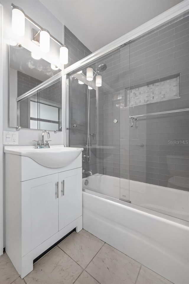1021 N Forest Ave, Orlando, FL 32803 - bathroom featuring bath / shower combo with glass door and vanity