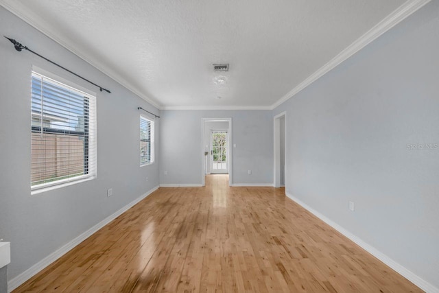 1021 N Forest Ave, Orlando, FL 32803 - unfurnished room with light wood-style floors, ornamental molding, baseboards, and a textured ceiling