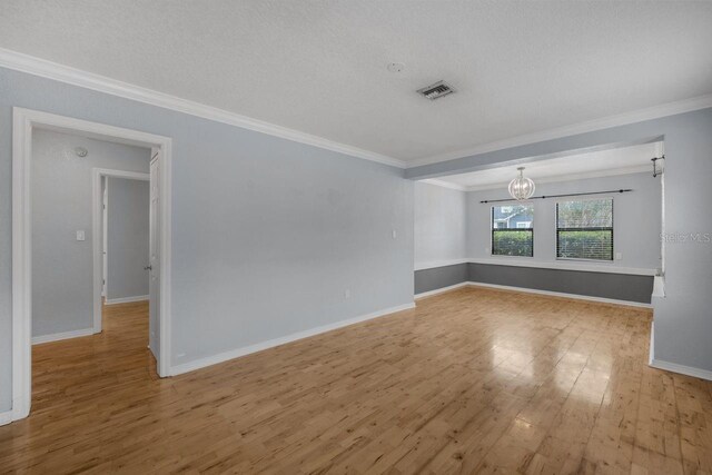 1021 N Forest Ave, Orlando, FL 32803 - empty room with ornamental molding, a chandelier, wood finished floors, and baseboards