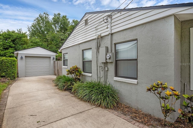 1021 N Forest Ave, Orlando, FL 32803 - view of home's exterior with stucco siding, an outbuilding, and concrete driveway