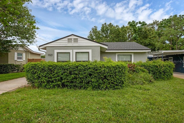 1021 N Forest Ave, Orlando, FL 32803 - ranch-style home with a front lawn and stucco siding