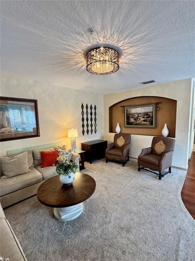 10350 Lake District Ln Unit S, Orlando, FL 32832 - living room with a textured ceiling, carpet, and a chandelier