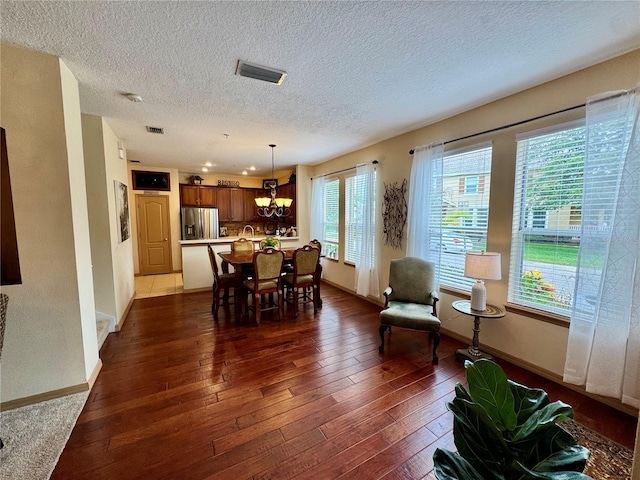 10350 Lake District Ln Unit S, Orlando, FL 32832 - dining area with a textured ceiling, a chandelier, baseboards, and dark wood-style floors