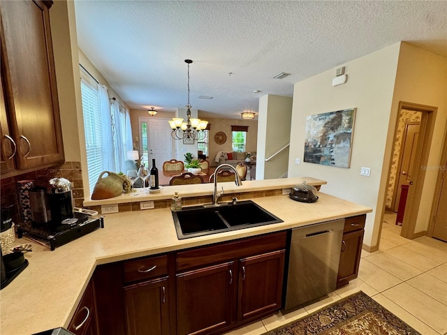 10350 Lake District Ln Unit S, Orlando, FL 32832 - kitchen featuring a sink, stainless steel dishwasher, a peninsula, tasteful backsplash, and light countertops