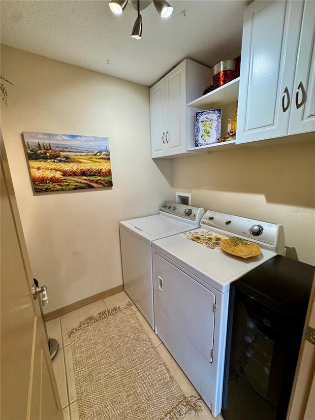 10350 Lake District Ln Unit S, Orlando, FL 32832 - laundry room featuring washing machine and dryer, cabinet space, light tile patterned floors, and baseboards