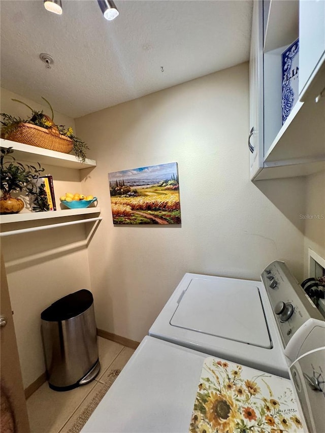 10350 Lake District Ln Unit S, Orlando, FL 32832 - laundry room with cabinet space, washing machine and clothes dryer, baseboards, and a textured ceiling