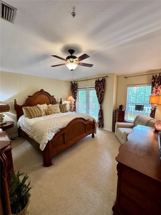 10350 Lake District Ln Unit S, Orlando, FL 32832 - bedroom featuring light colored carpet, ceiling fan, baseboards, and a textured ceiling