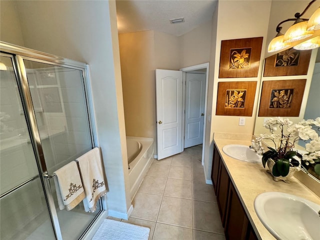 10350 Lake District Ln Unit S, Orlando, FL 32832 - full bathroom with double vanity, a bath, a shower stall, and tile patterned floors