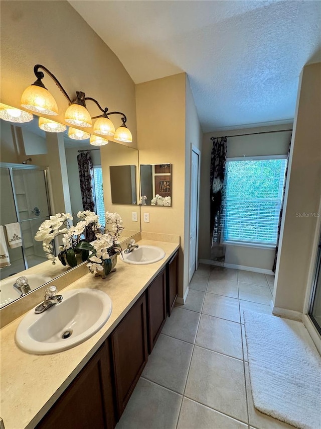 10350 Lake District Ln Unit S, Orlando, FL 32832 - bathroom featuring tile patterned floors, a stall shower, double vanity, and baseboards