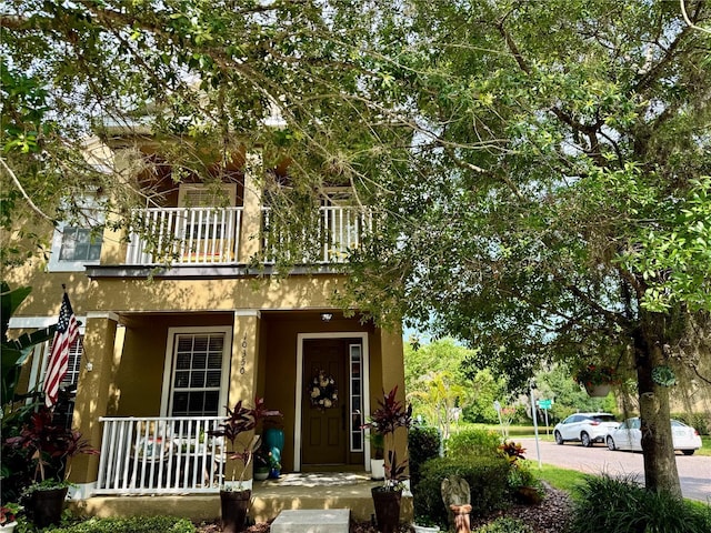 10350 Lake District Ln Unit S, Orlando, FL 32832 - view of front of home featuring a balcony, covered porch, and stucco siding