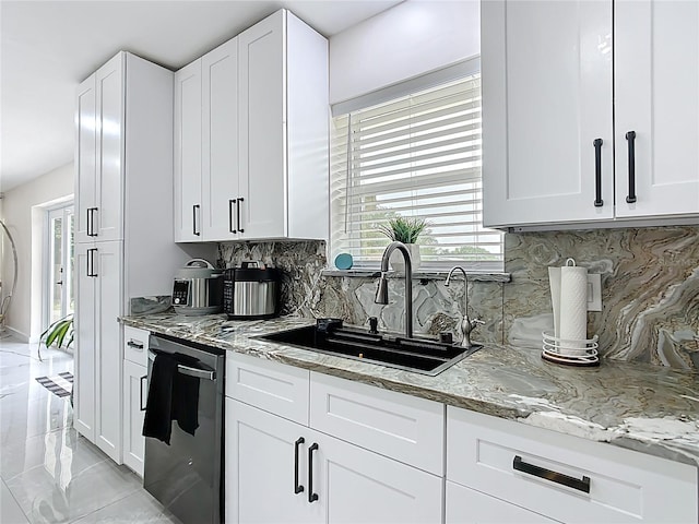 516 Petes Ln, Davenport, FL 33837 - kitchen with a sink, backsplash, light stone counters, and white cabinetry