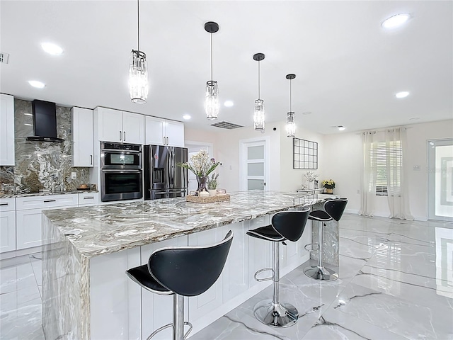 516 Petes Ln, Davenport, FL 33837 - kitchen featuring light marble finish floors, stainless steel appliances, wall chimney exhaust hood, recessed lighting, and decorative backsplash