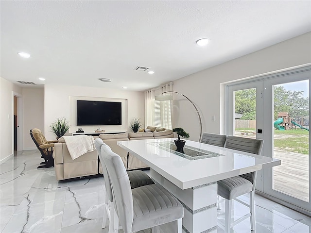 516 Petes Ln, Davenport, FL 33837 - dining area with light marble finish flooring, recessed lighting, and baseboards