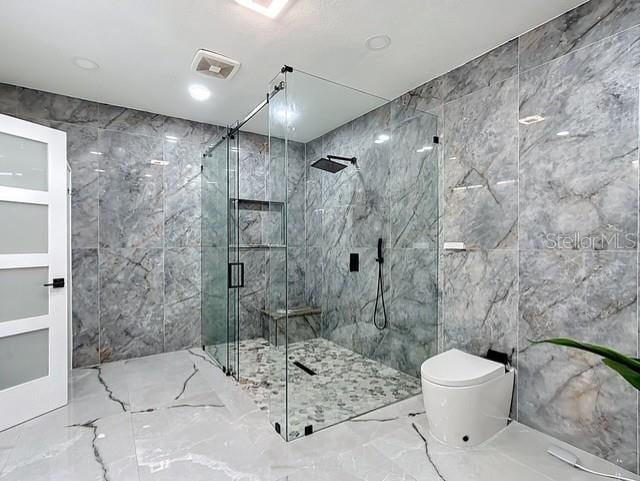 516 Petes Ln, Davenport, FL 33837 - full bathroom featuring marble tiled floors, tile walls, a marble finish shower, and toilet