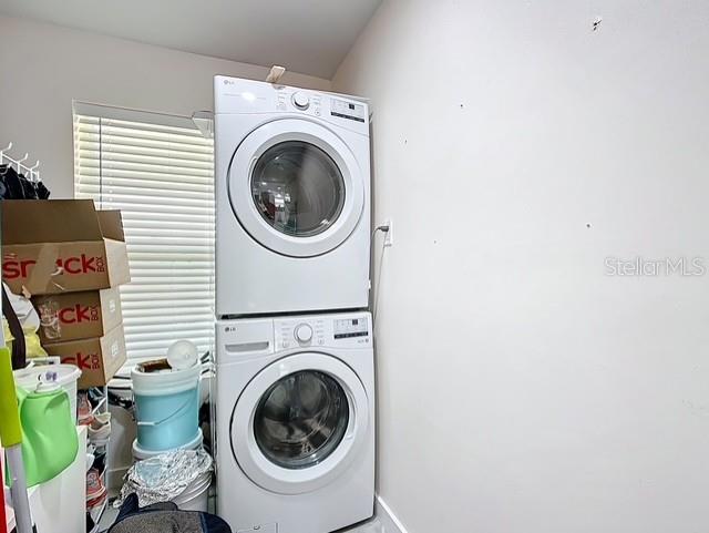 516 Petes Ln, Davenport, FL 33837 - washroom featuring stacked washer / dryer