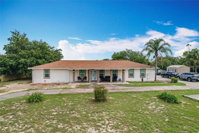 516 Petes Ln, Davenport, FL 33837 - ranch-style home featuring covered porch, a front yard, and stucco siding