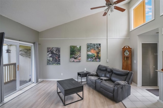 1051 S Highland St Unit 5E, Mount Dora, FL 32757 - living area with a ceiling fan, high vaulted ceiling, plenty of natural light, light wood finished floors, and baseboards