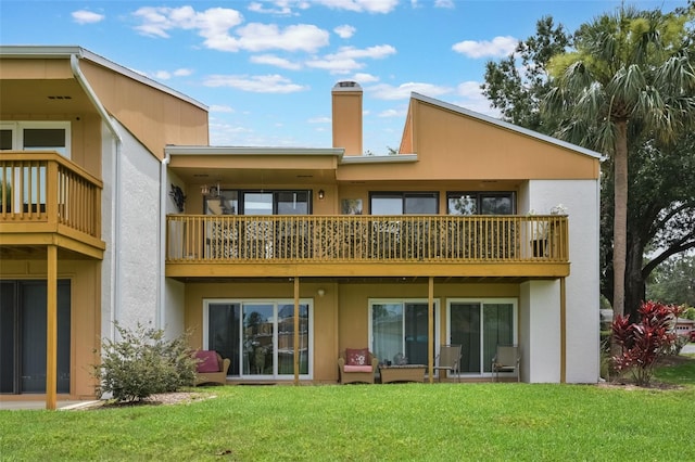 1051 S Highland St Unit 5E, Mount Dora, FL 32757 - rear view of house with a yard, a balcony, stucco siding, and a chimney