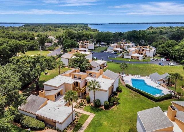 1051 S Highland St Unit 5E, Mount Dora, FL 32757 - aerial view of residential area featuring a nearby body of water, a pool, and a heavily wooded area