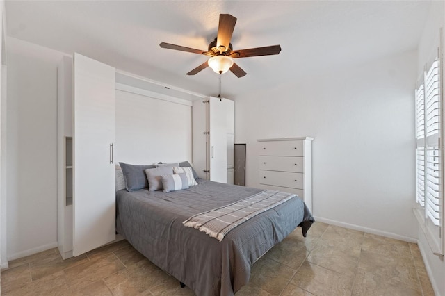 6210 Sun Blvd Unit 206, Saint Petersburg, FL 33715 - bedroom featuring baseboards, ceiling fan, and light stone finish floors