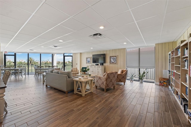 6210 Sun Blvd Unit 206, Saint Petersburg, FL 33715 - living room featuring floor to ceiling windows, dark wood-style flooring, and wood walls