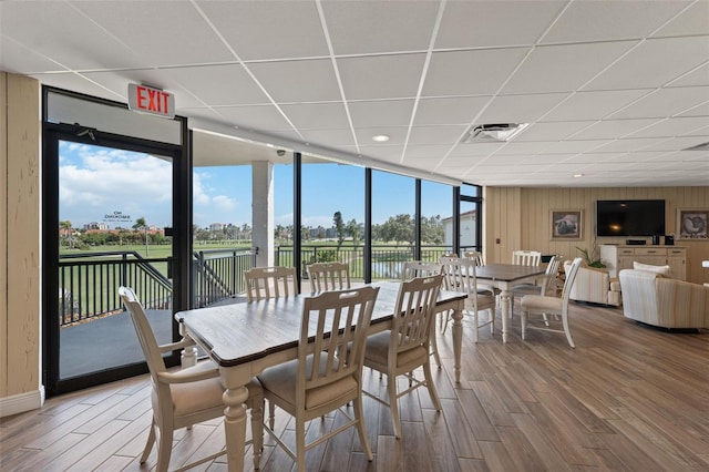 6210 Sun Blvd Unit 206, Saint Petersburg, FL 33715 - dining space featuring floor to ceiling windows, a drop ceiling, wood finished floors, recessed lighting, and wood walls