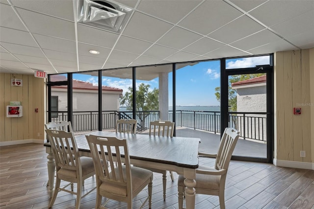 6210 Sun Blvd Unit 206, Saint Petersburg, FL 33715 - dining space featuring a paneled ceiling, wood finished floors, floor to ceiling windows, a water view, and baseboards