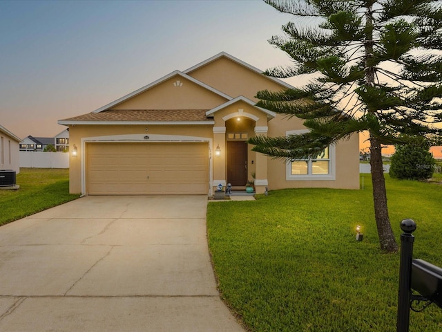 204 Cotswold Cir, Davenport, FL 33837 - view of front of home with stucco siding, concrete driveway, and a garage
