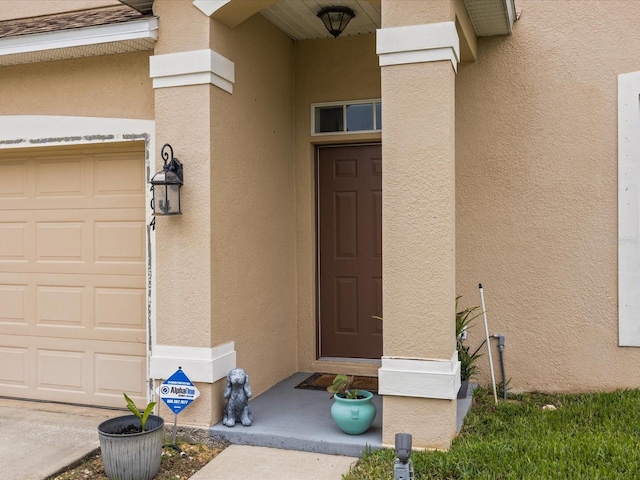 204 Cotswold Cir, Davenport, FL 33837 - entrance to property with stucco siding and an attached garage