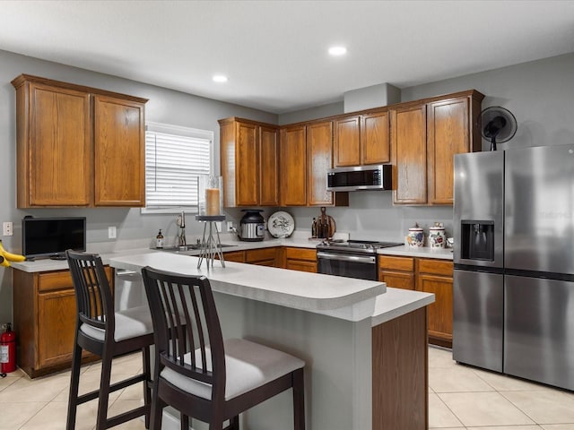 204 Cotswold Cir, Davenport, FL 33837 - kitchen with stainless steel appliances, a sink, light countertops, brown cabinetry, and recessed lighting