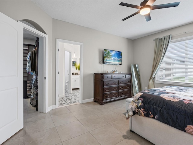 204 Cotswold Cir, Davenport, FL 33837 - bedroom with a spacious closet, a closet, light tile patterned floors, connected bathroom, and baseboards