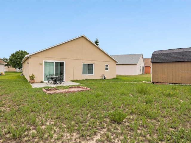 204 Cotswold Cir, Davenport, FL 33837 - rear view of property with a yard, a patio area, stucco siding, and an outdoor structure