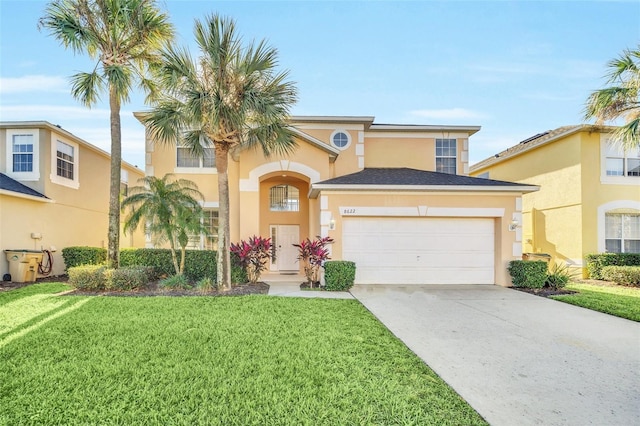 8622 La Isla Dr, Kissimmee, FL 34747 - mediterranean / spanish-style home featuring an attached garage, stucco siding, a front lawn, and driveway
