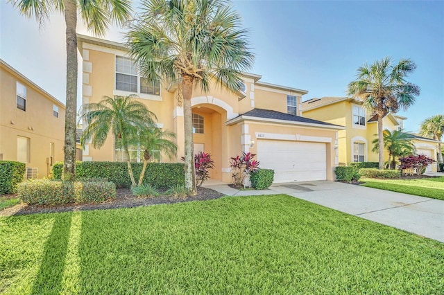 8622 La Isla Dr, Kissimmee, FL 34747 - mediterranean / spanish-style home featuring stucco siding, driveway, an attached garage, and a front lawn