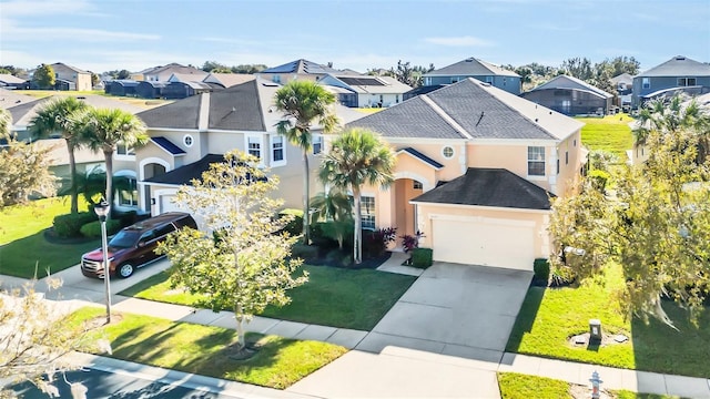 8622 La Isla Dr, Kissimmee, FL 34747 - view of front facade featuring a residential view, stucco siding, driveway, and a garage
