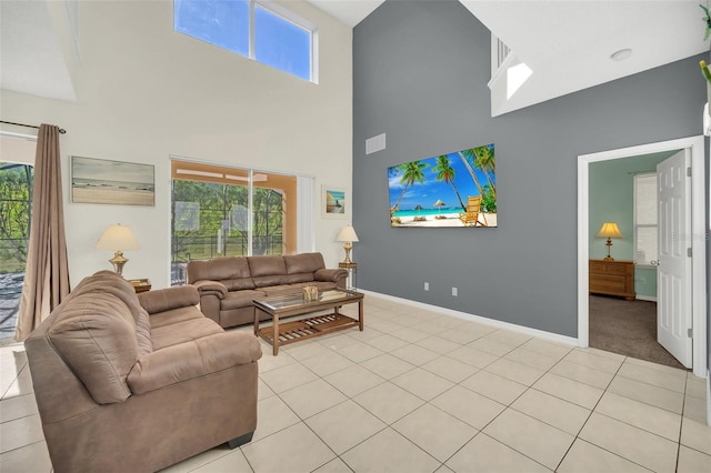 8622 La Isla Dr, Kissimmee, FL 34747 - living room featuring a towering ceiling, plenty of natural light, baseboards, and light tile patterned flooring
