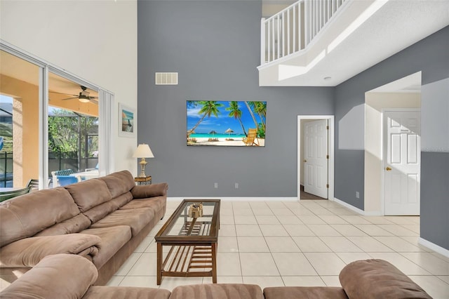 8622 La Isla Dr, Kissimmee, FL 34747 - living area featuring a towering ceiling, baseboards, a ceiling fan, and light tile patterned floors