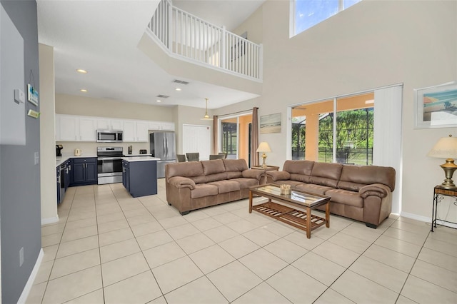 8622 La Isla Dr, Kissimmee, FL 34747 - living area featuring plenty of natural light, light tile patterned floors, baseboards, a towering ceiling, and recessed lighting