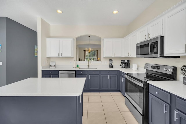 8622 La Isla Dr, Kissimmee, FL 34747 - kitchen with appliances with stainless steel finishes, a sink, white cabinetry, light countertops, and recessed lighting