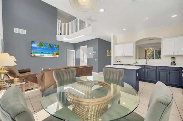 8622 La Isla Dr, Kissimmee, FL 34747 - dining space featuring a chandelier, light tile patterned floors, recessed lighting, baseboards, and a towering ceiling