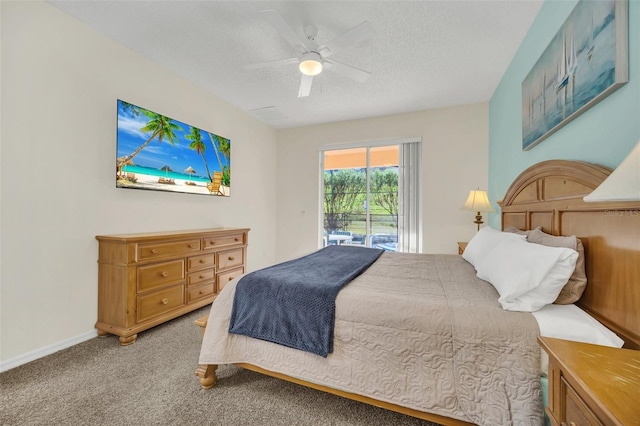 8622 La Isla Dr, Kissimmee, FL 34747 - bedroom with access to outside, light colored carpet, ceiling fan, baseboards, and a textured ceiling
